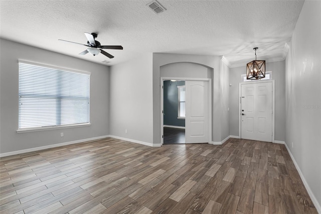 6539 Chagford Ln, Windermere, FL 34786 - unfurnished room with ceiling fan, a chandelier, wood finished floors, and a textured ceiling