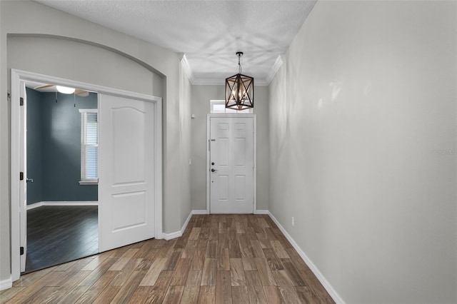 6539 Chagford Ln, Windermere, FL 34786 - entrance foyer featuring wood finished floors, a chandelier, and a ceiling fan