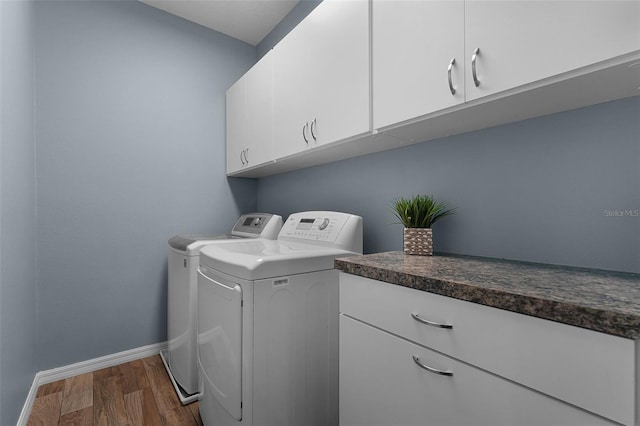 6539 Chagford Ln, Windermere, FL 34786 - washroom with washing machine and dryer, cabinet space, and dark wood-type flooring