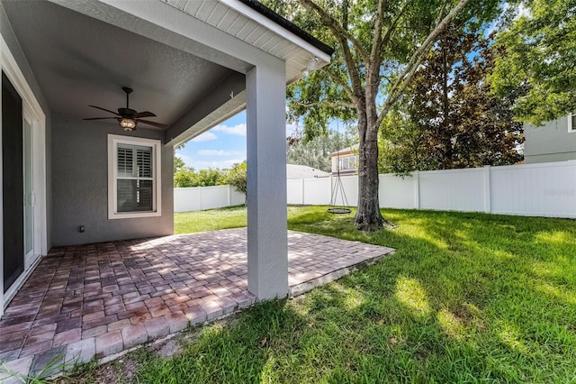 6539 Chagford Ln, Windermere, FL 34786 - fenced backyard featuring a ceiling fan and a patio area