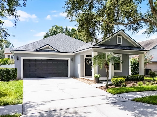 6539 Chagford Ln, Windermere, FL 34786 - view of front of home featuring an attached garage, concrete driveway, roof with shingles, stucco siding, and covered porch