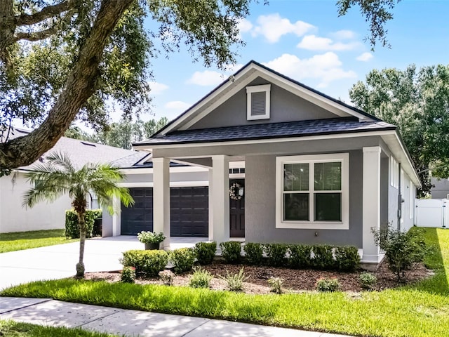 6539 Chagford Ln, Windermere, FL 34786 - view of front of home featuring a garage, concrete driveway, roof with shingles, stucco siding, and covered porch