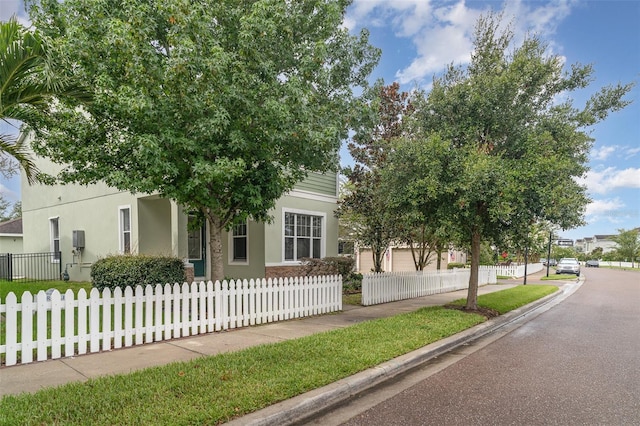11307 Grand Park Ave, Riverview, FL 33578 - obstructed view of property featuring stucco siding and a fenced front yard