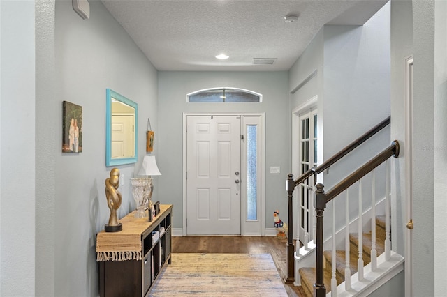 1005 Thunderhead Ln, Minneola, FL 34715 - entryway featuring wood finished floors, a textured ceiling, and stairway