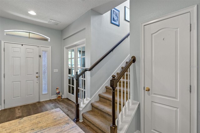 1005 Thunderhead Ln, Minneola, FL 34715 - foyer entrance featuring a textured ceiling, dark wood-type flooring, stairway, and recessed lighting