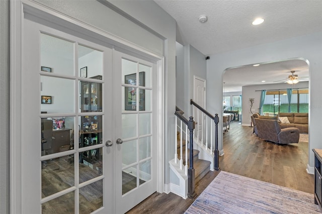 1005 Thunderhead Ln, Minneola, FL 34715 - foyer entrance featuring arched walkways, dark wood-style flooring, a ceiling fan, stairway, and a textured ceiling