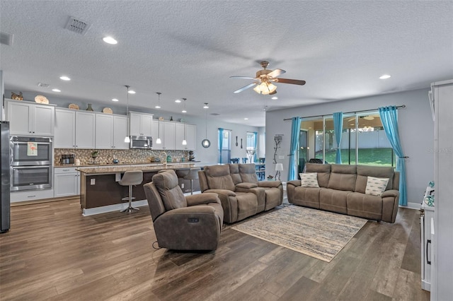 1005 Thunderhead Ln, Minneola, FL 34715 - living room with wood finished floors, a textured ceiling, ceiling fan, plenty of natural light, and recessed lighting