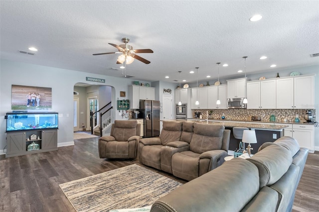 1005 Thunderhead Ln, Minneola, FL 34715 - living room with arched walkways, a textured ceiling, a ceiling fan, dark wood-style flooring, and recessed lighting