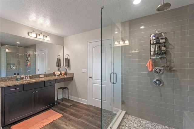 1005 Thunderhead Ln, Minneola, FL 34715 - full bath featuring a shower stall, wood finished floors, vanity, and a textured ceiling