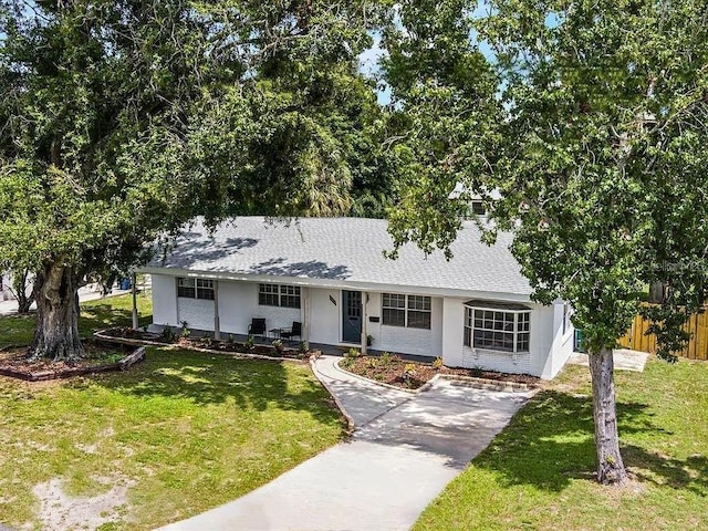 904 15th St NE, Winter Haven, FL 33881 - view of front of house with concrete driveway, a shingled roof, and stucco siding