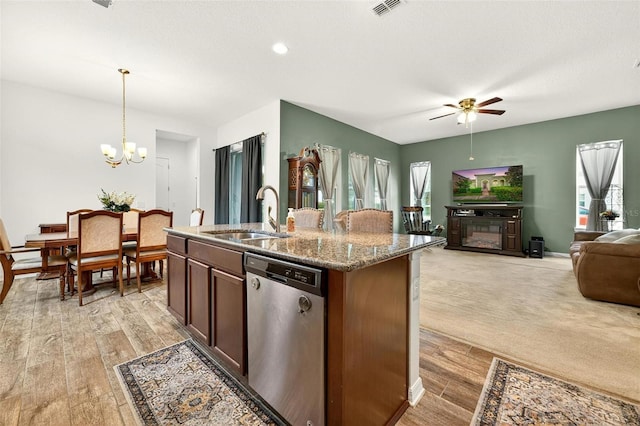 1559 Bayfront Park Aly, Winter Garden, FL 34787 - kitchen with dishwasher, ceiling fan, open floor plan, a chandelier, and stone counters