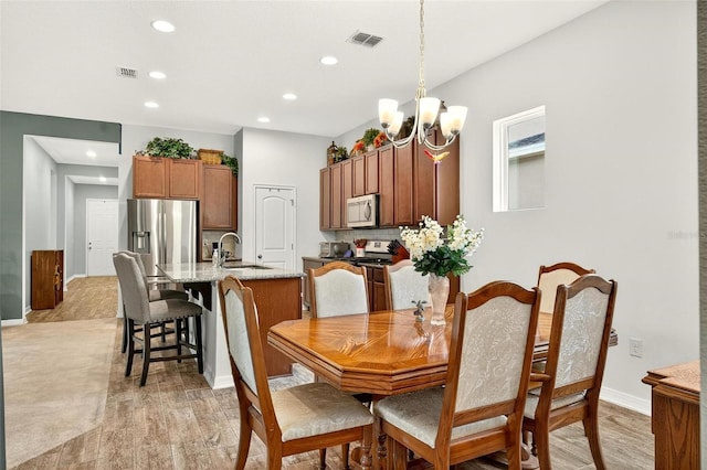 1559 Bayfront Park Aly, Winter Garden, FL 34787 - dining room featuring recessed lighting, light wood-style floors, and a chandelier