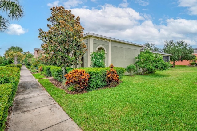 1559 Bayfront Park Aly, Winter Garden, FL 34787 - view of side of home featuring stucco siding and a yard