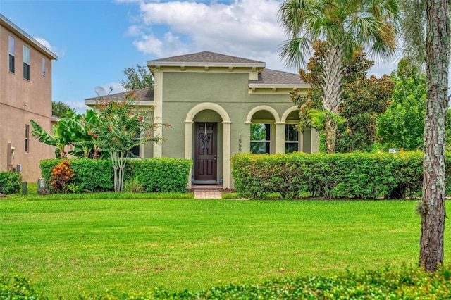 1559 Bayfront Park Aly, Winter Garden, FL 34787 - mediterranean / spanish-style home featuring stucco siding, a front yard, and roof with shingles