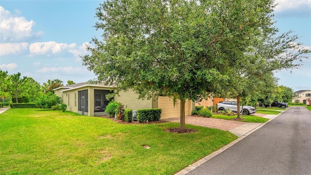 1559 Bayfront Park Aly, Winter Garden, FL 34787 - view of front facade with decorative driveway, a front yard, stucco siding, and a garage
