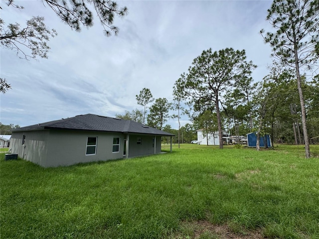 2011 W Tacoma Dr, Citrus Springs, FL 34434 - view of green lawn featuring a storage shed
