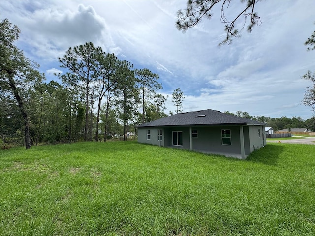 2011 W Tacoma Dr, Citrus Springs, FL 34434 - back of house with a lawn and stucco siding