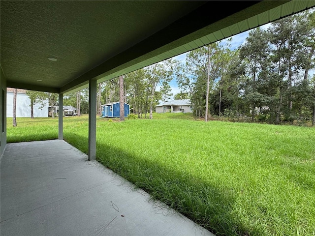 2011 W Tacoma Dr, Citrus Springs, FL 34434 - view of green lawn featuring a patio area and an outbuilding