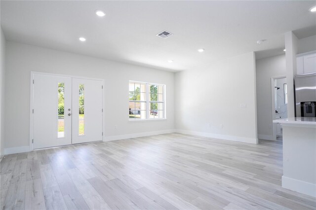 2011 W Tacoma Dr, Citrus Springs, FL 34434 - unfurnished living room featuring light wood-style flooring, recessed lighting, and french doors