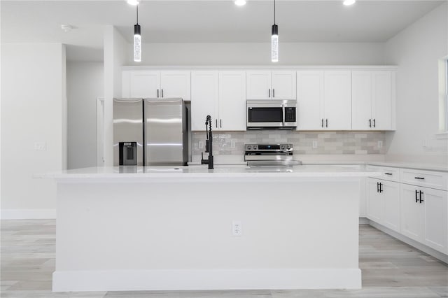 2011 W Tacoma Dr, Citrus Springs, FL 34434 - kitchen featuring appliances with stainless steel finishes, a kitchen island with sink, decorative backsplash, white cabinets, and recessed lighting