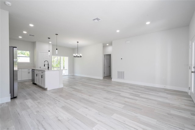 2011 W Tacoma Dr, Citrus Springs, FL 34434 - unfurnished living room with a chandelier, recessed lighting, and light wood-style floors