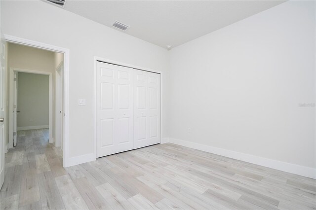 2011 W Tacoma Dr, Citrus Springs, FL 34434 - unfurnished bedroom featuring light wood-type flooring and a closet