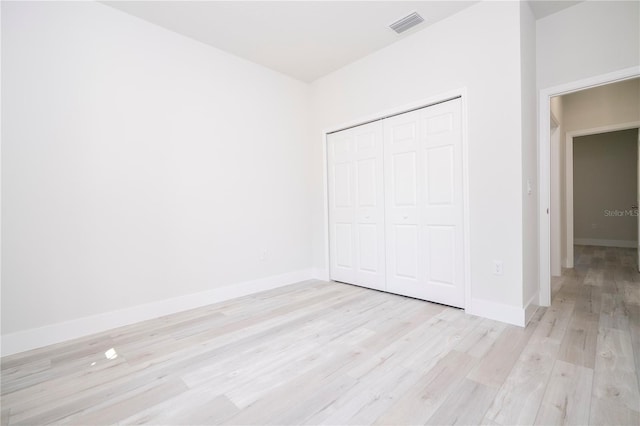 2011 W Tacoma Dr, Citrus Springs, FL 34434 - unfurnished bedroom with light wood finished floors and a closet