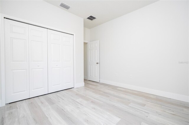 2011 W Tacoma Dr, Citrus Springs, FL 34434 - unfurnished bedroom featuring light wood-type flooring and a closet