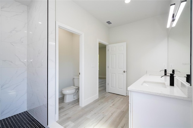 2011 W Tacoma Dr, Citrus Springs, FL 34434 - bathroom with double vanity, a marble finish shower, and wood finished floors