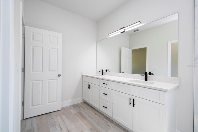 2011 W Tacoma Dr, Citrus Springs, FL 34434 - bathroom featuring double vanity and wood finished floors
