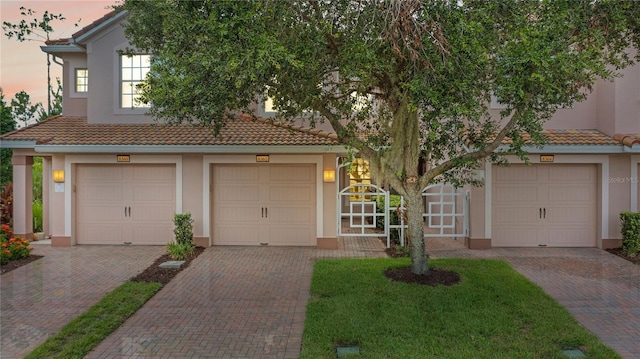 8362 Bella Tierra Ct Unit 10146, Davenport, FL 33896 - view of front of house with stucco siding, a tiled roof, and decorative driveway