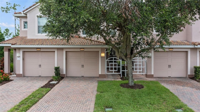 8362 Bella Tierra Ct Unit 10146, Davenport, FL 33896 - view of front of house with a tile roof, stucco siding, and decorative driveway