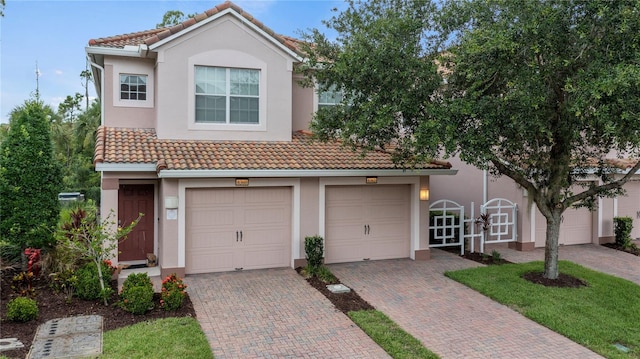 8362 Bella Tierra Ct Unit 10146, Davenport, FL 33896 - view of front of property featuring a tiled roof, stucco siding, and decorative driveway