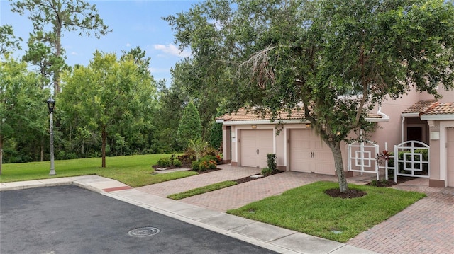 8362 Bella Tierra Ct Unit 10146, Davenport, FL 33896 - view of front of home with decorative driveway, stucco siding, a front lawn, and a tile roof