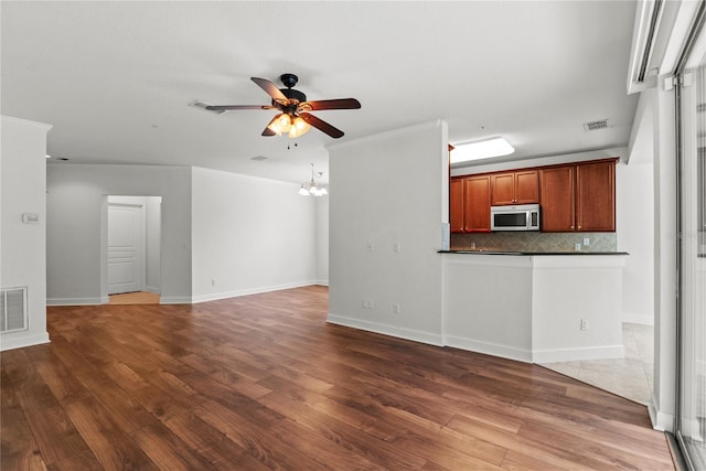 8362 Bella Tierra Ct Unit 10146, Davenport, FL 33896 - unfurnished living room featuring a ceiling fan and wood finished floors