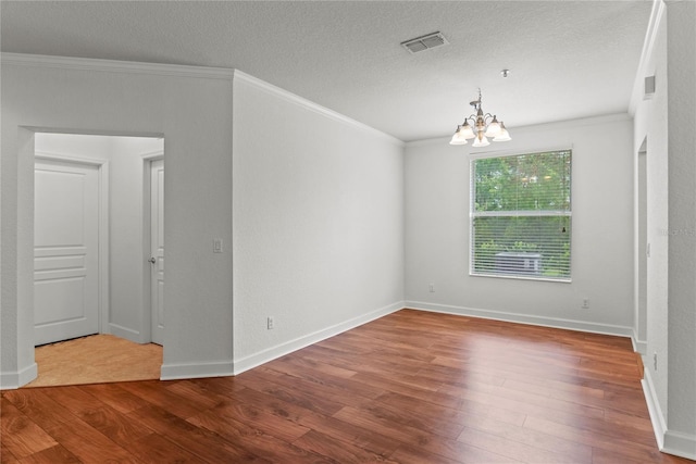 8362 Bella Tierra Ct Unit 10146, Davenport, FL 33896 - unfurnished room with ornamental molding, wood-type flooring, a chandelier, and a textured ceiling