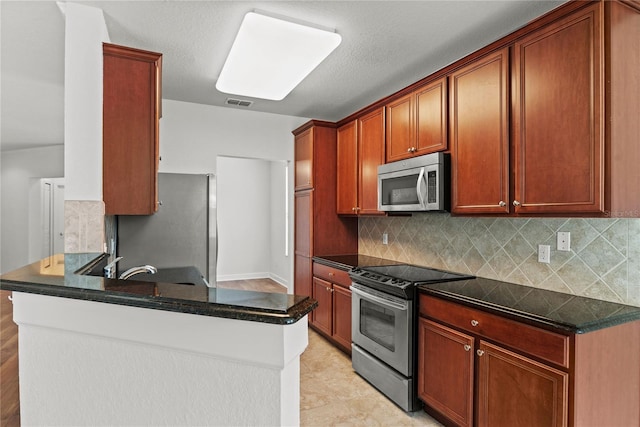 8362 Bella Tierra Ct Unit 10146, Davenport, FL 33896 - kitchen featuring stainless steel appliances, decorative backsplash, and a peninsula