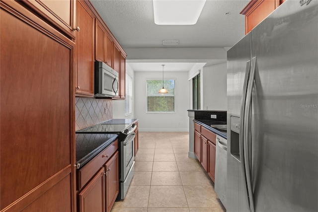 8362 Bella Tierra Ct Unit 10146, Davenport, FL 33896 - kitchen featuring stainless steel appliances, decorative backsplash, light tile patterned floors, brown cabinetry, and pendant lighting