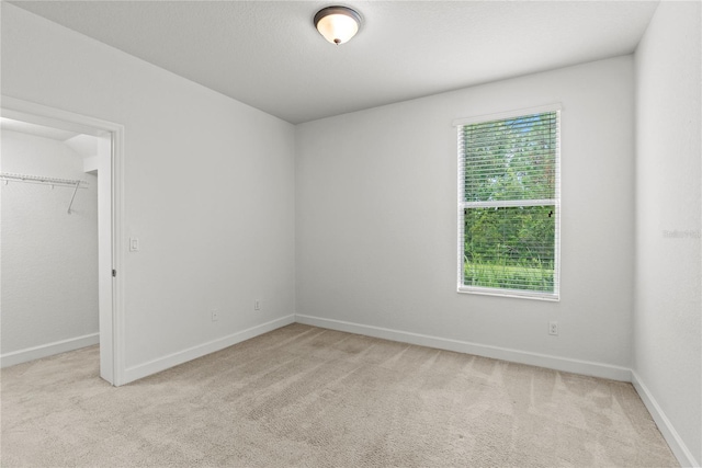 8362 Bella Tierra Ct Unit 10146, Davenport, FL 33896 - unfurnished bedroom featuring multiple windows, a walk in closet, and carpet