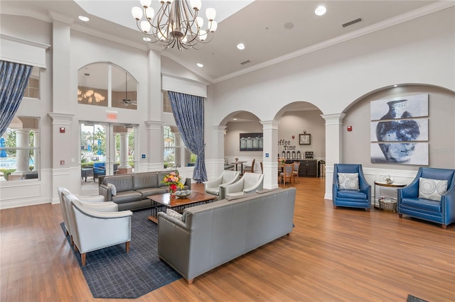 8362 Bella Tierra Ct Unit 10146, Davenport, FL 33896 - living room featuring ornate columns, recessed lighting, wood finished floors, a chandelier, and a decorative wall
