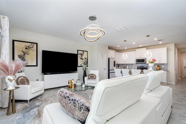 4828 Magnetite Loop, Mount Dora, FL 32757 - living room featuring a chandelier and recessed lighting