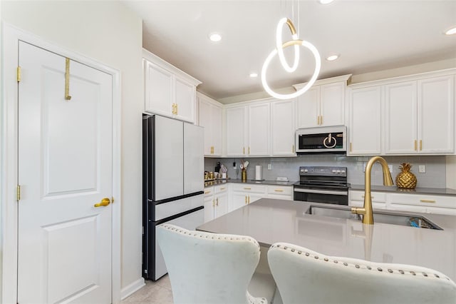 4828 Magnetite Loop, Mount Dora, FL 32757 - kitchen featuring white appliances, backsplash, white cabinetry, pendant lighting, and recessed lighting