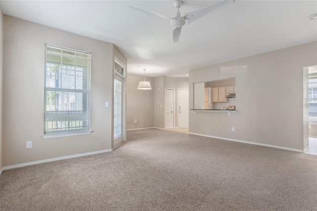 408 Summit Ridge Pl Unit 210, Longwood, FL 32779 - unfurnished living room with a ceiling fan and light carpet