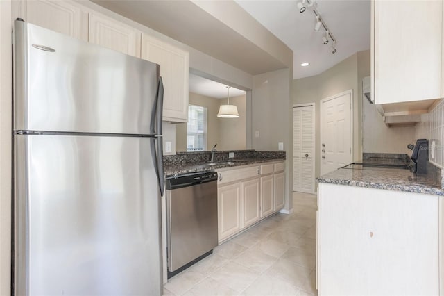 408 Summit Ridge Pl Unit 210, Longwood, FL 32779 - kitchen featuring appliances with stainless steel finishes, rail lighting, light tile patterned flooring, and dark stone countertops