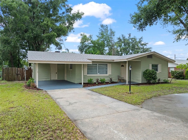 575 Ave M SE, Winter Haven, FL 33880 - ranch-style home with driveway, an attached carport, and roof with shingles