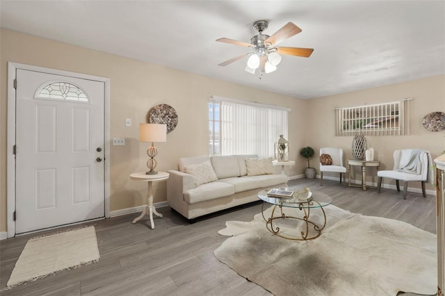 575 Ave M SE, Winter Haven, FL 33880 - living area with wood finished floors, healthy amount of natural light, and a ceiling fan
