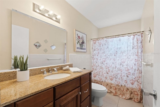 575 Ave M SE, Winter Haven, FL 33880 - bathroom featuring tile patterned floors, vanity, a wainscoted wall, tile walls, and shower / tub combo