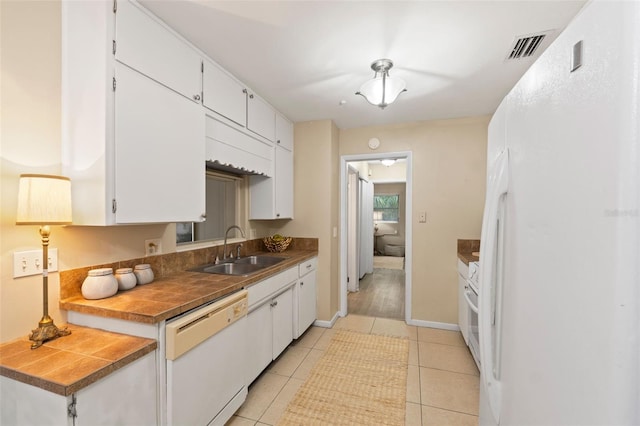 575 Ave M SE, Winter Haven, FL 33880 - kitchen featuring white appliances, white cabinets, and light tile patterned floors