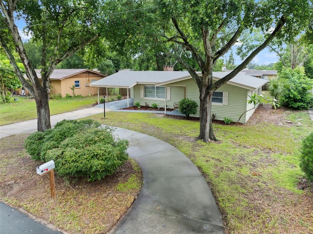 575 Ave M SE, Winter Haven, FL 33880 - single story home with concrete driveway, a front yard, and an attached carport