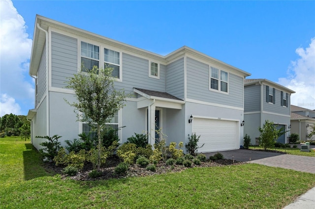 17571 Saw Palmeto Ave, Clermont, FL 34714 - traditional-style home with asphalt driveway, a garage, stucco siding, and a front yard